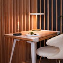 
Umage Asteria Table Lamp in White on a wooden desk