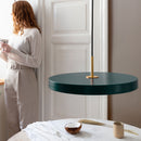 Umage Asteria Pendant Light in Green above a table with a woman looking out the window in the background