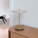 Umage Asteria Table Lamp in white on a sideboard.