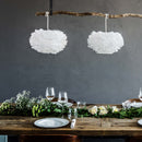 Umage Mini EOS Feather Lamshade hang as a pair over a rustic dining table 